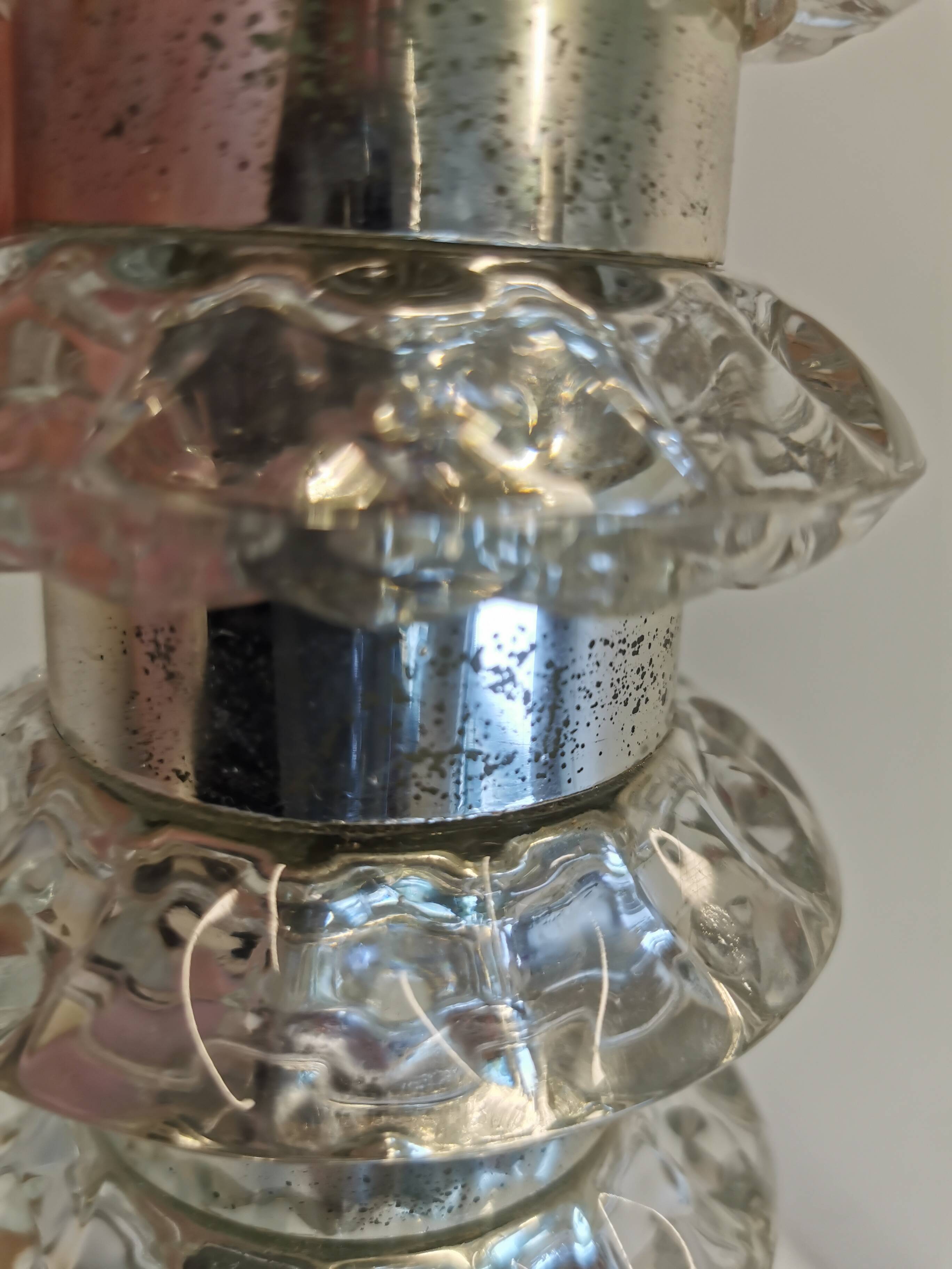 Table lamp made of transparent crystal glass and silver colored spacers.