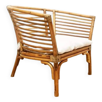 Rattan armchair and white linen cushion