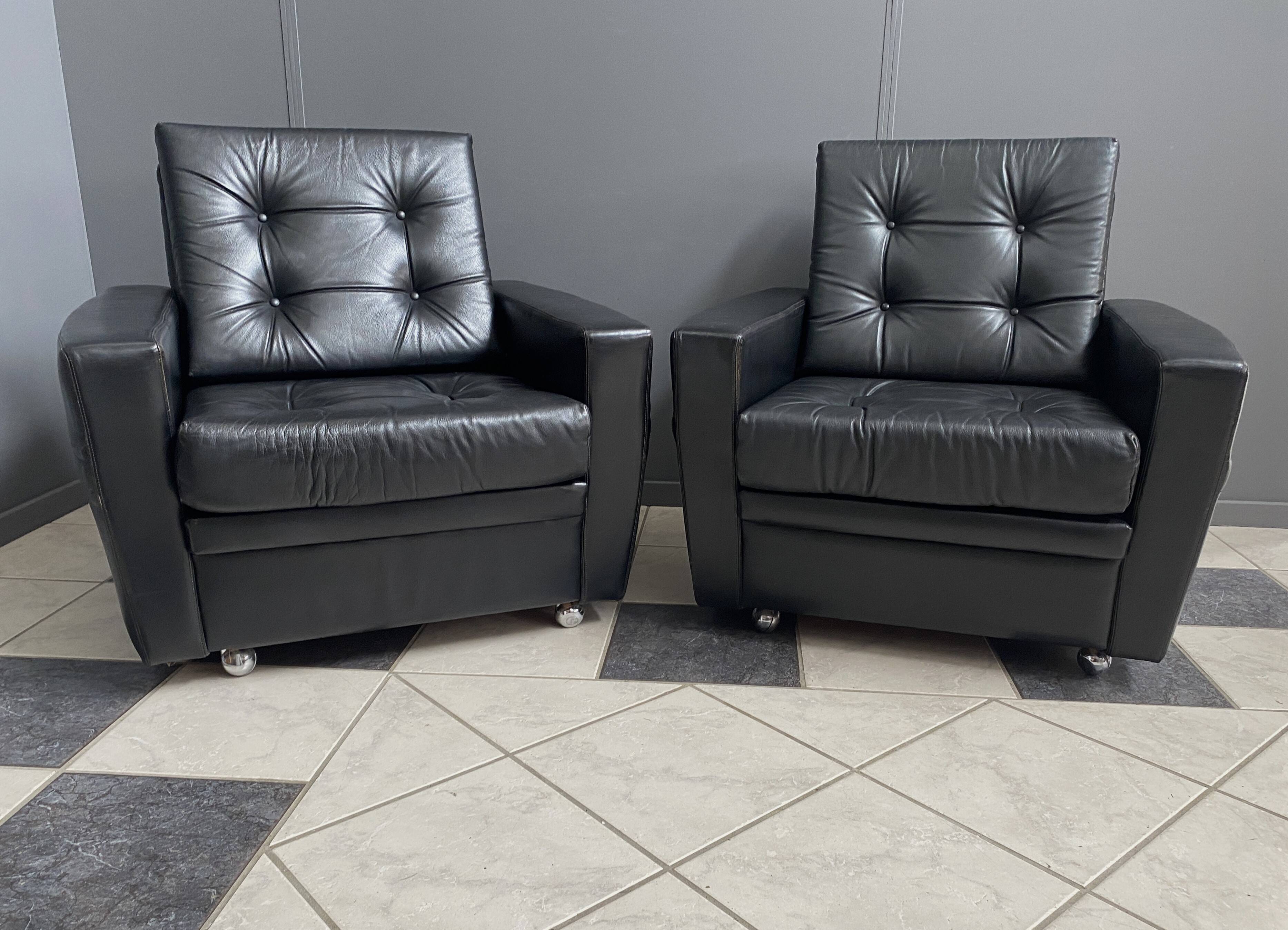 2 Black leather arm chairs 1960s on wheels