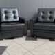 2 Black leather arm chairs 1960s on wheels