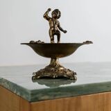 Vintage brass ashtray from the 1940s with a nude boy figurine on a footed base.