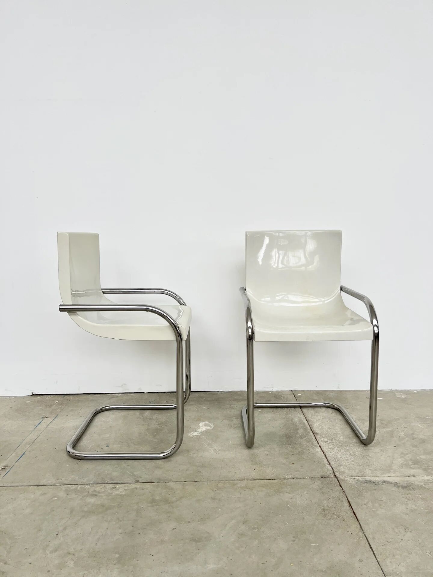 Pair of white moulded shell chairs with chrome tube — Space Age 70s