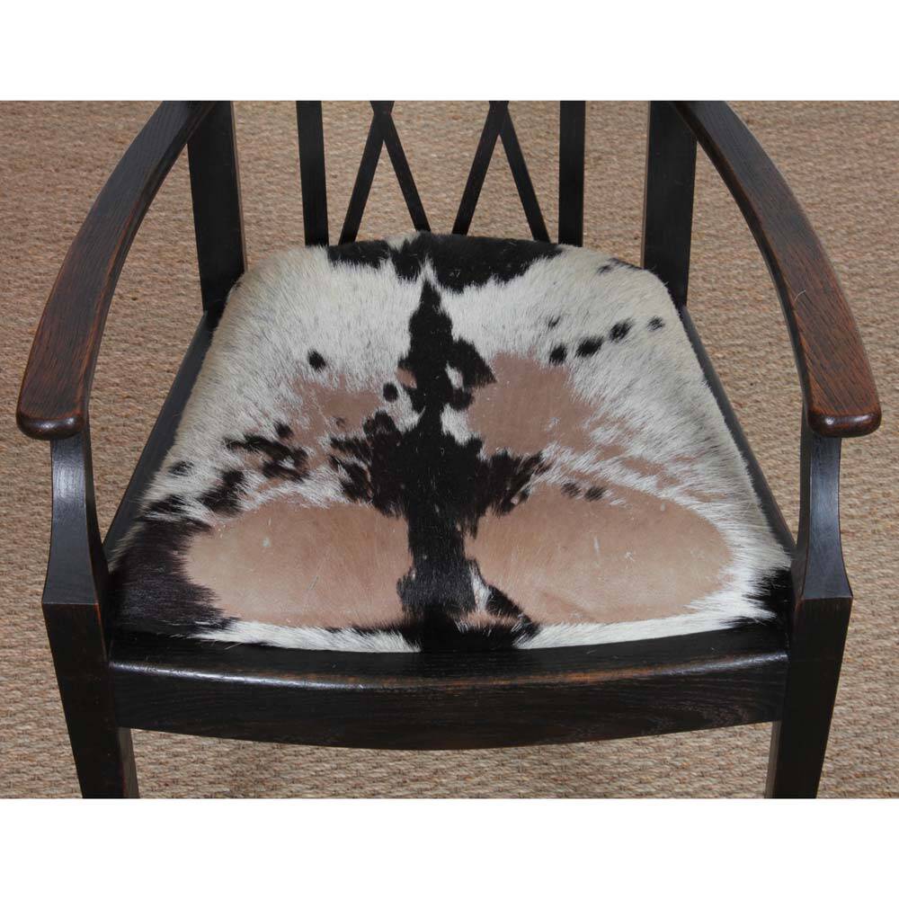 Bridge armchair in wood and leather, work from the early 20th century.