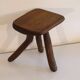 Patinated tripod stool in solid wood from the 1960s.