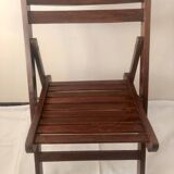 Pair of folding chairs in dark wooden slats