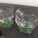 2 faceted champagne glasses with green feet, 1930s