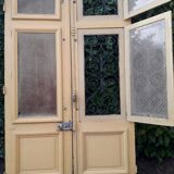 Porte d'entrée cintrée double en chêne, grilles et verre, XIXème