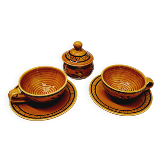 Pair of glazed earthenware breakfast cups and sugar bowl