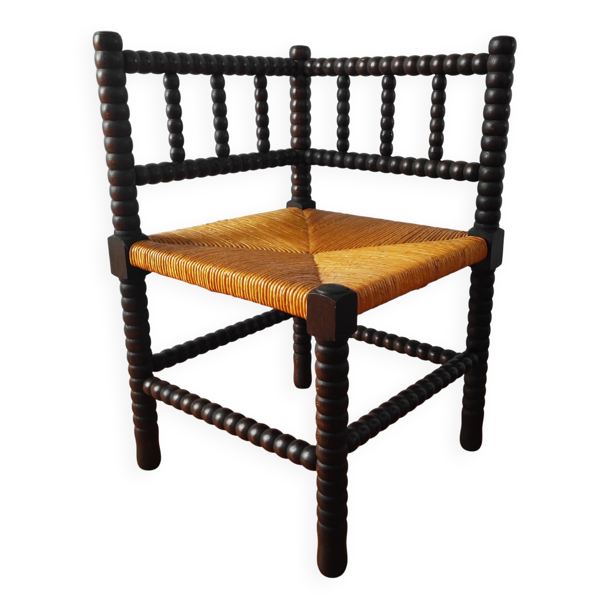 Antique corner chair made of turned wood.