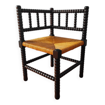 Antique corner chair made of turned wood.