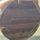 Antique oval mirror in gilded stucco with ornamentation