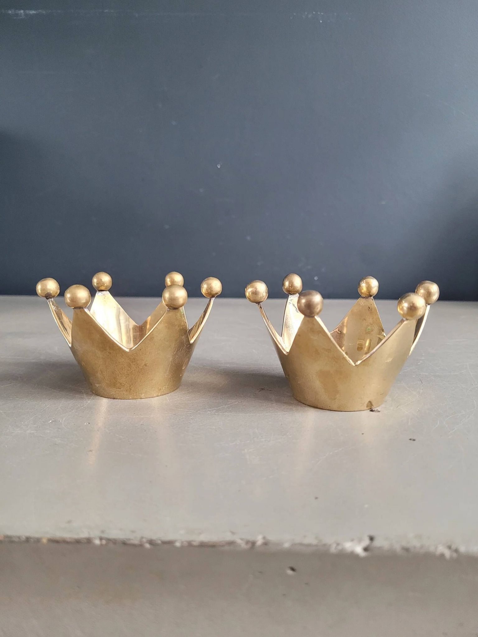 Pair of crown candle holders in brass
