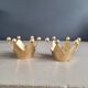 Pair of crown candle holders in brass