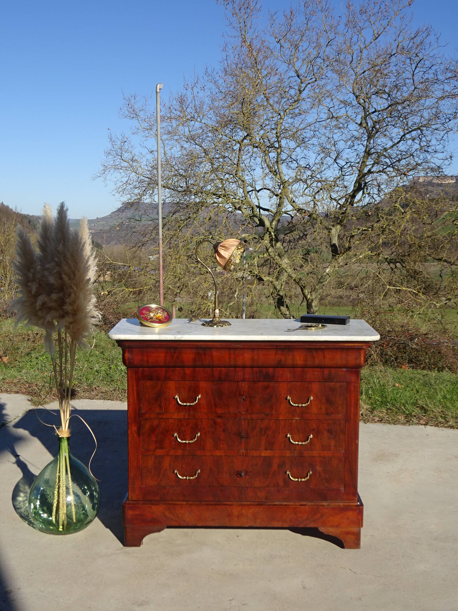 Antique mahogany chest of drawers with white marble.