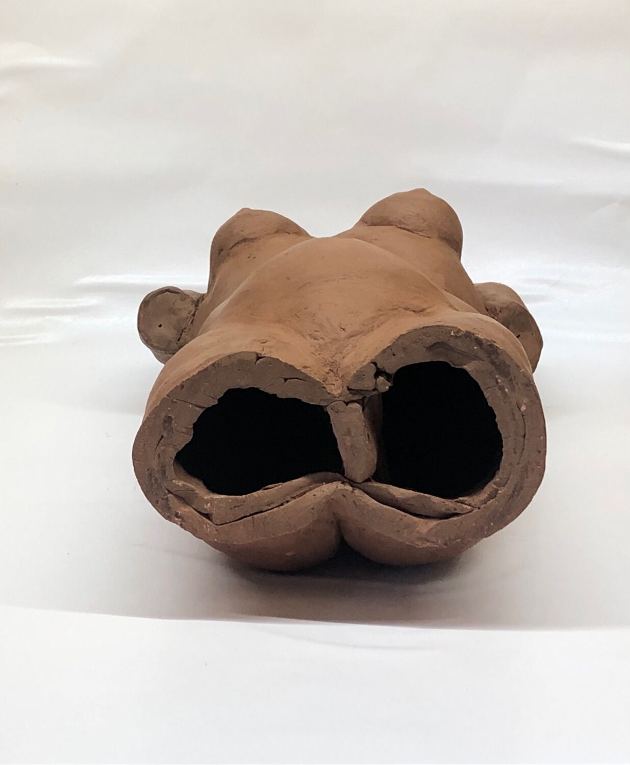 School bust of a female body in red clay terracotta