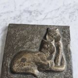 Bas-relief plaque of a rabbit in brown patina, seated cat
