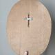 Oval wooden relief portrait of a cardinal.