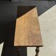 Brown Indonesian teak coffee table, with a border and cylindrical legs H40 L103.