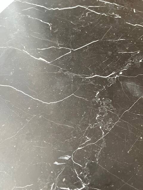 Black marble coffee table with brass legs.