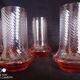 Art Deco orangeade service in pink-orange glass, twisted model.