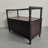 Natural wood chest forming a bench, ringed shoulders