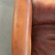 Vintage sheepskin club armchair finished with black piping