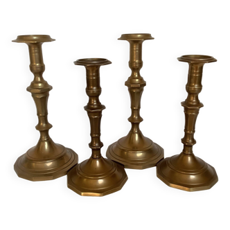 Four brass candle holders