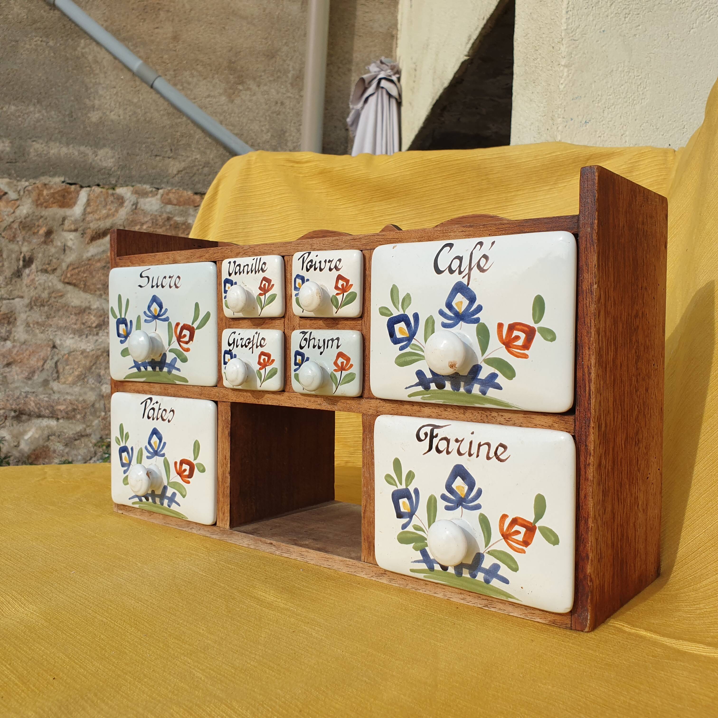 Vintage wooden spice rack with ceramic drawers