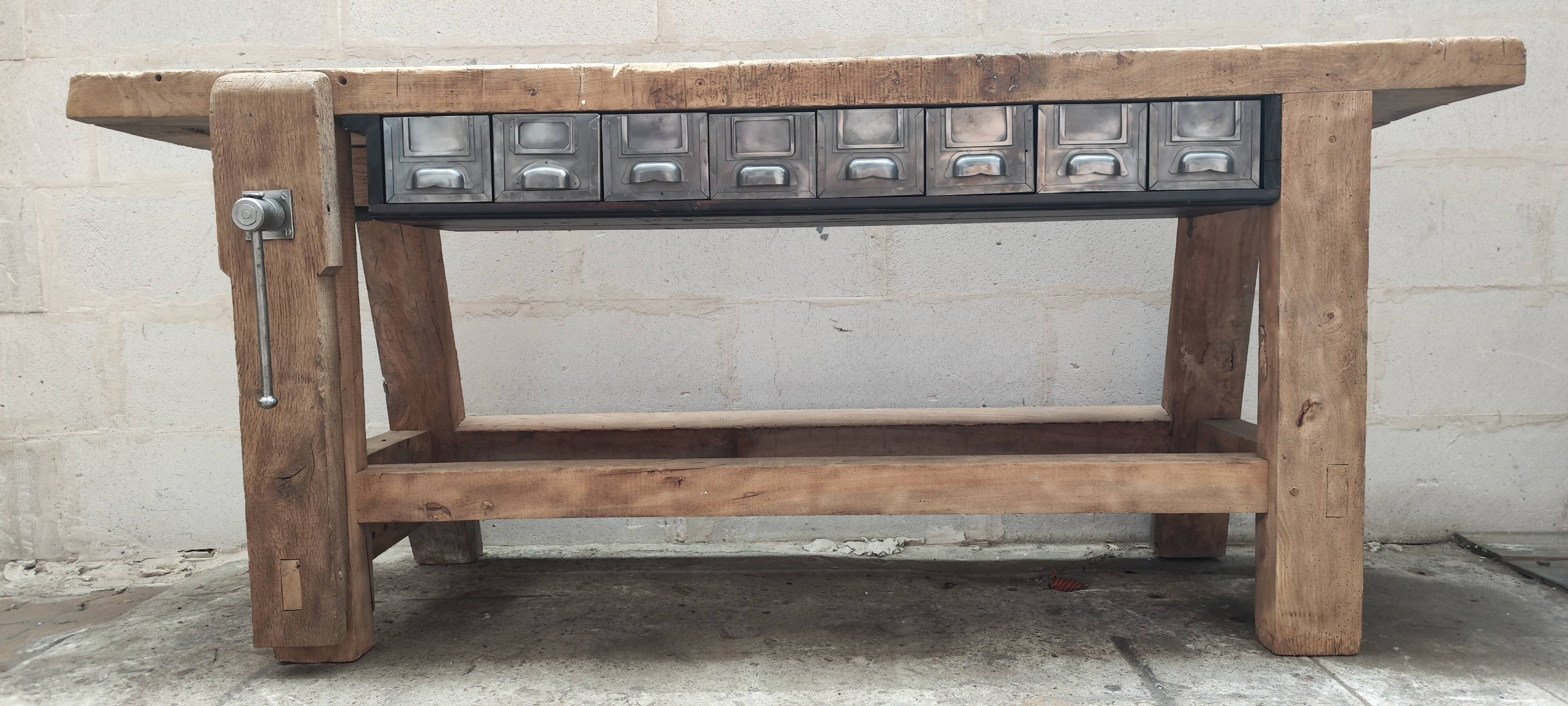 Old carpenter's workbench with eight metal drawers, industrial console