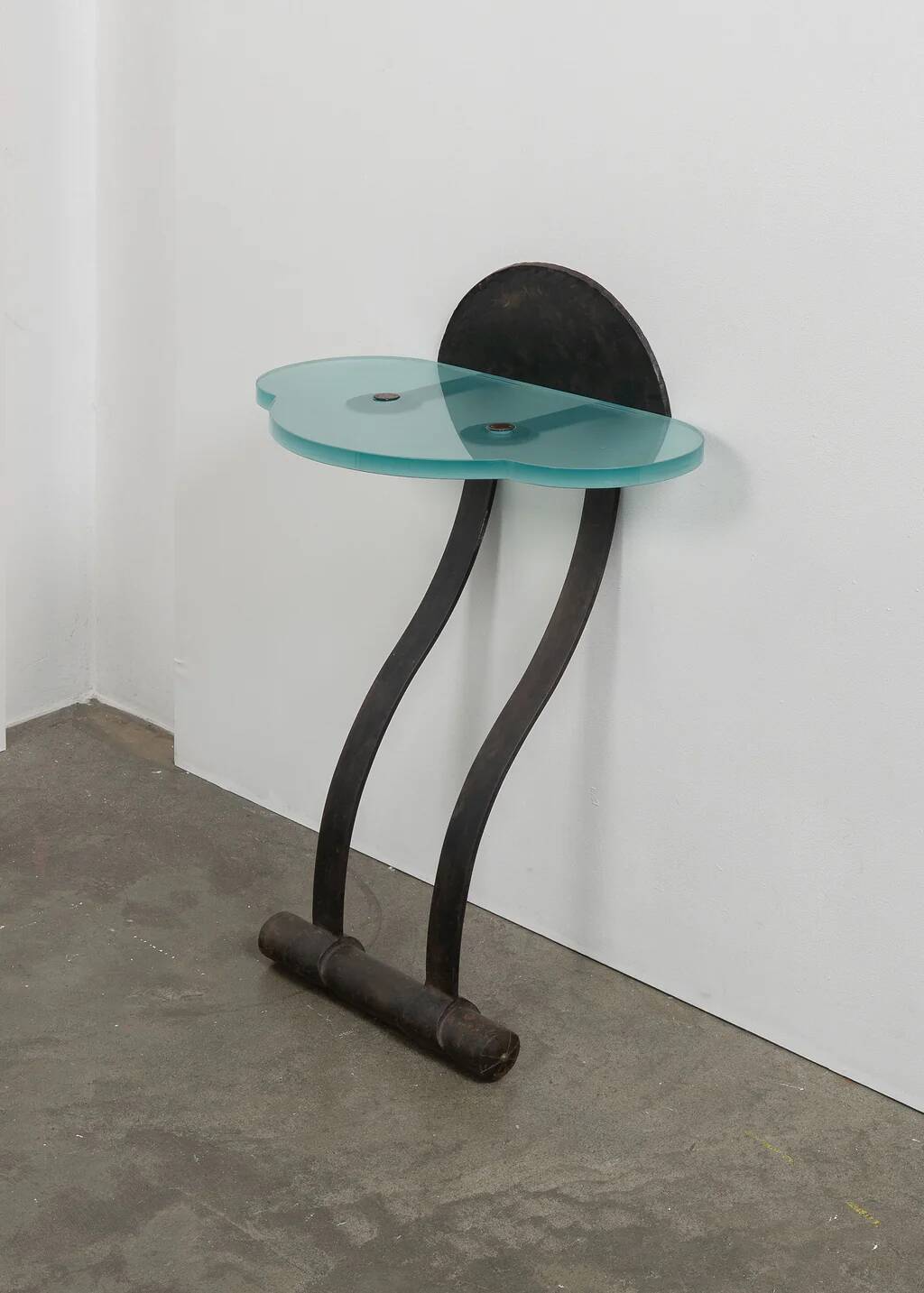 Artisanal wrought iron and cast glass leaning console table