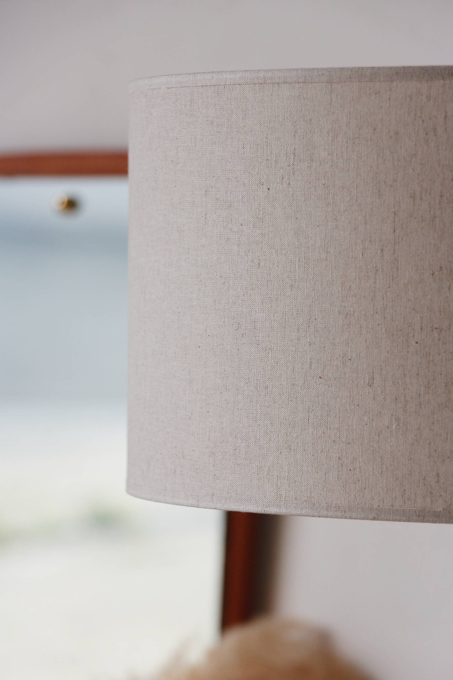 Vintage floor lamp in teak and brass with a cream shade.