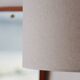 Vintage floor lamp in teak and brass with a cream shade.