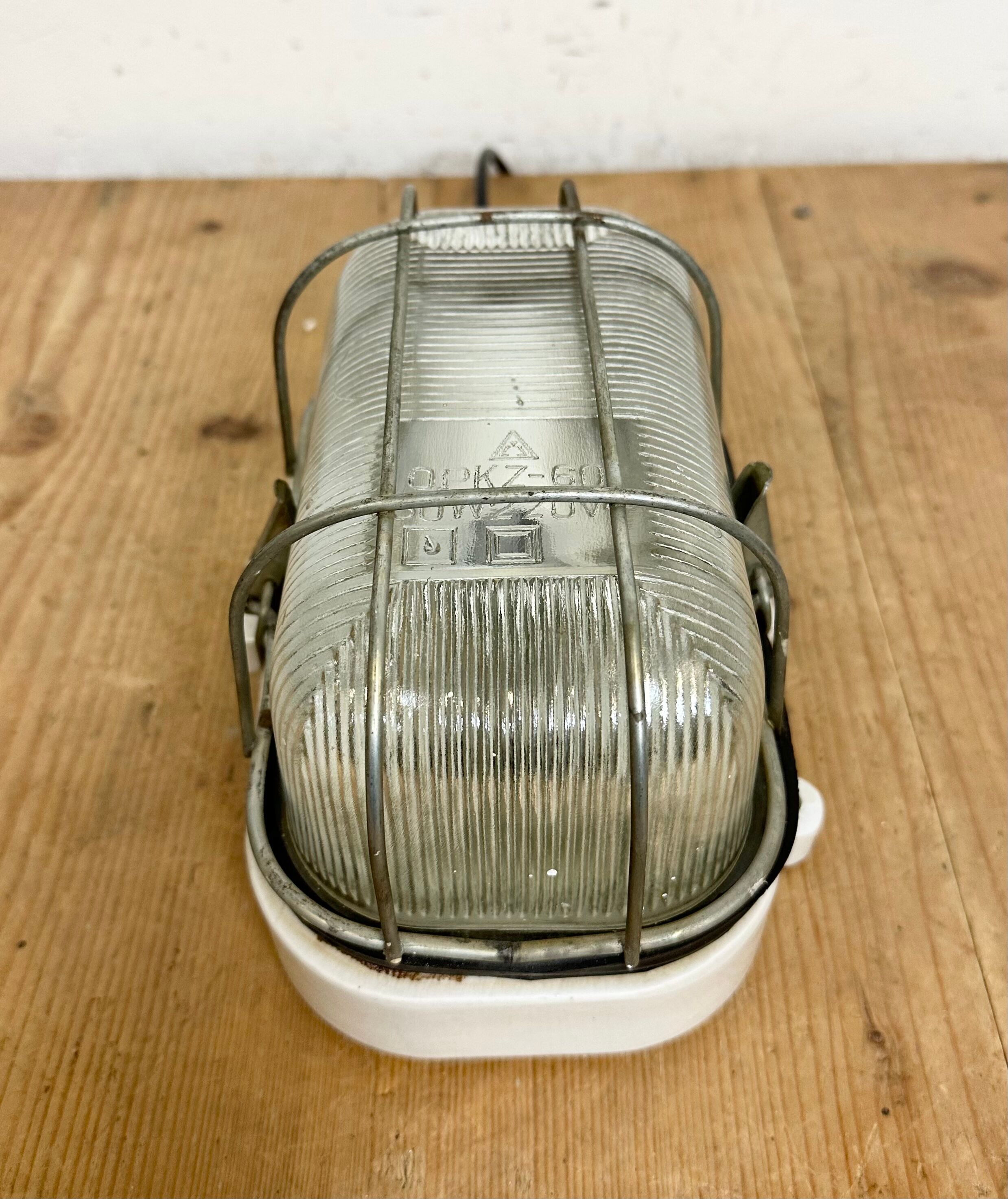 Industrial white porcelain cage wall light with ribbed glass, 1970s