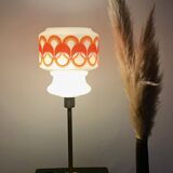 Table lamp with a vintage globe with orange patterns from the 70s and a golden base