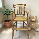 Antique bamboo caned baby chair from the early 20th century.