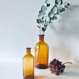 Duo of ancient apothecary flakes in amber glass