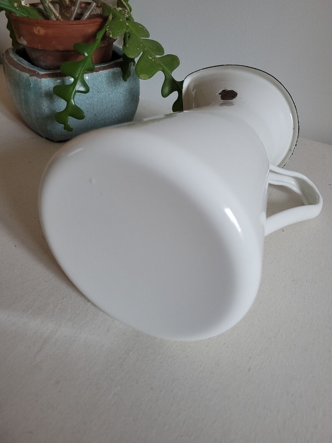 White enamelled metal jug