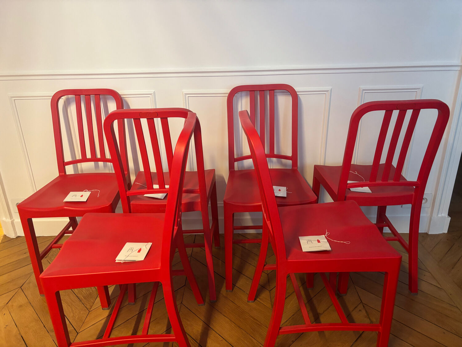 Set of 6 red Emeco chairs