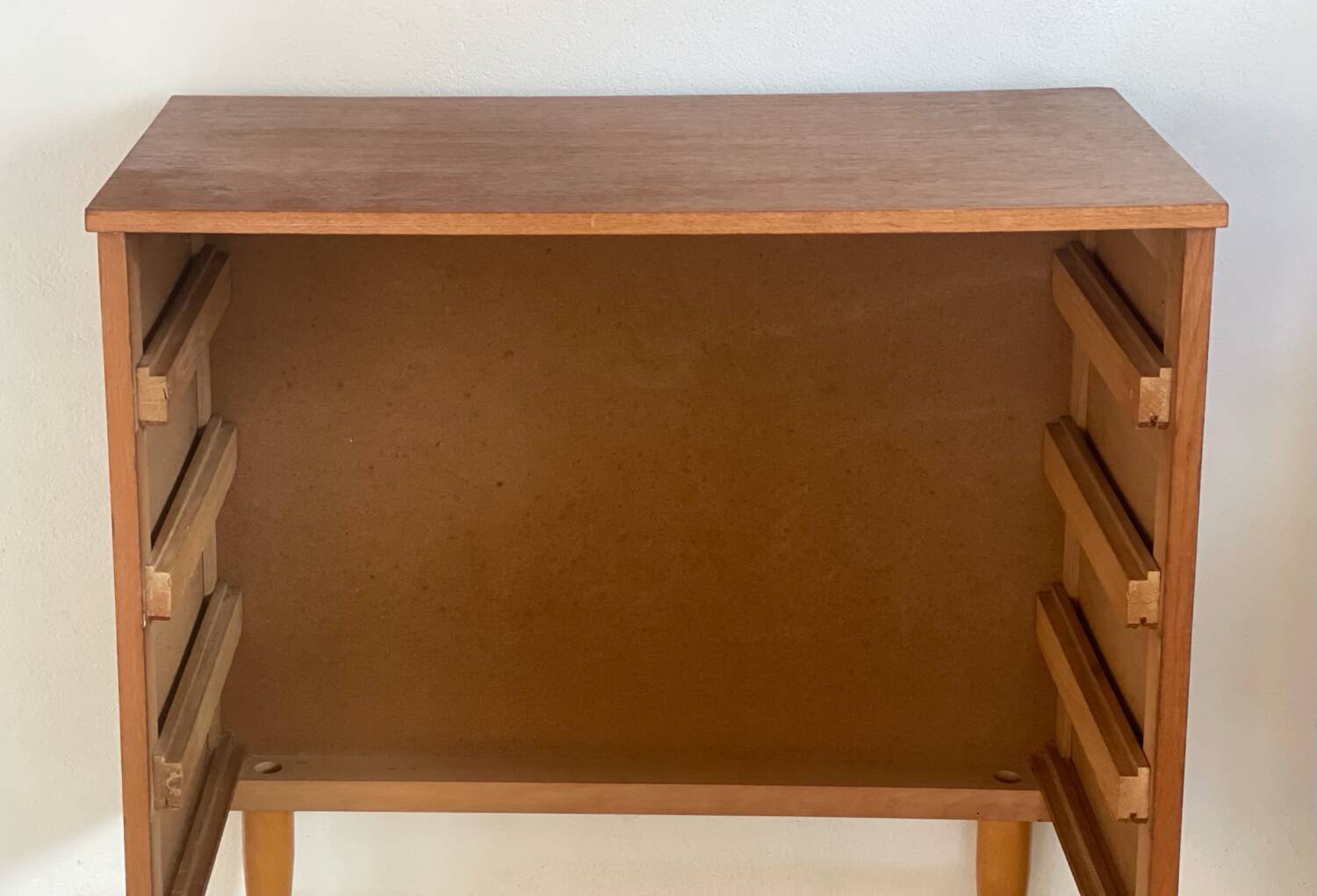 Vintage 1960s chest of drawers with covered handles.