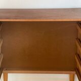 Vintage 1960s chest of drawers with covered handles.