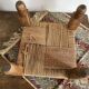 Low stool with carved wood and braided cord.