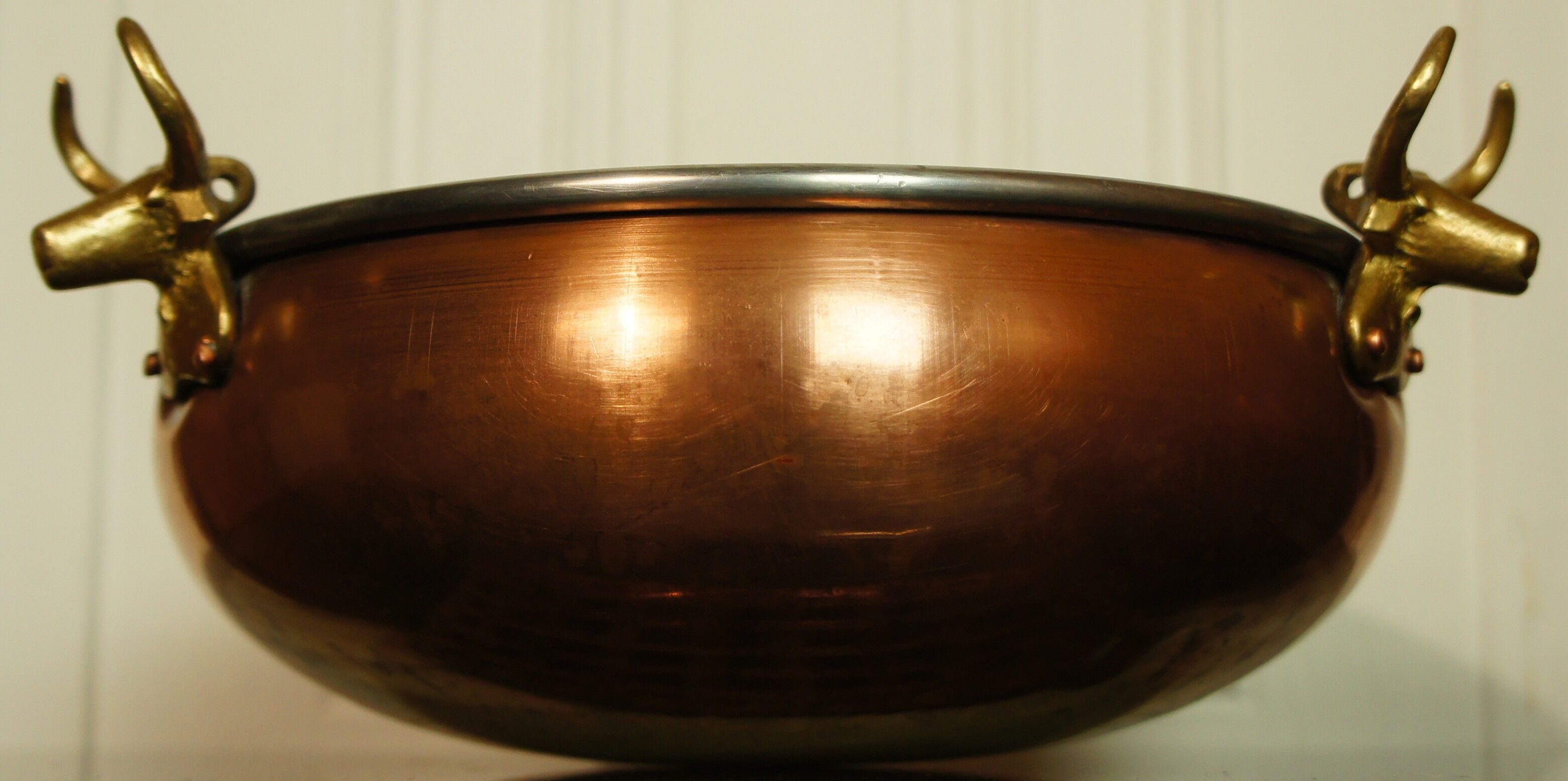 Copper cauldron with golden bronze bull heads