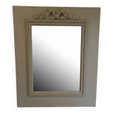 Wooden mirror with patinated beige knot