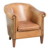 Comfortable sheepskin club armchair in a cognac colour