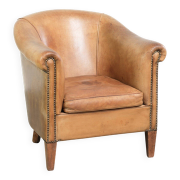 Comfortable sheepskin club armchair in a cognac colour