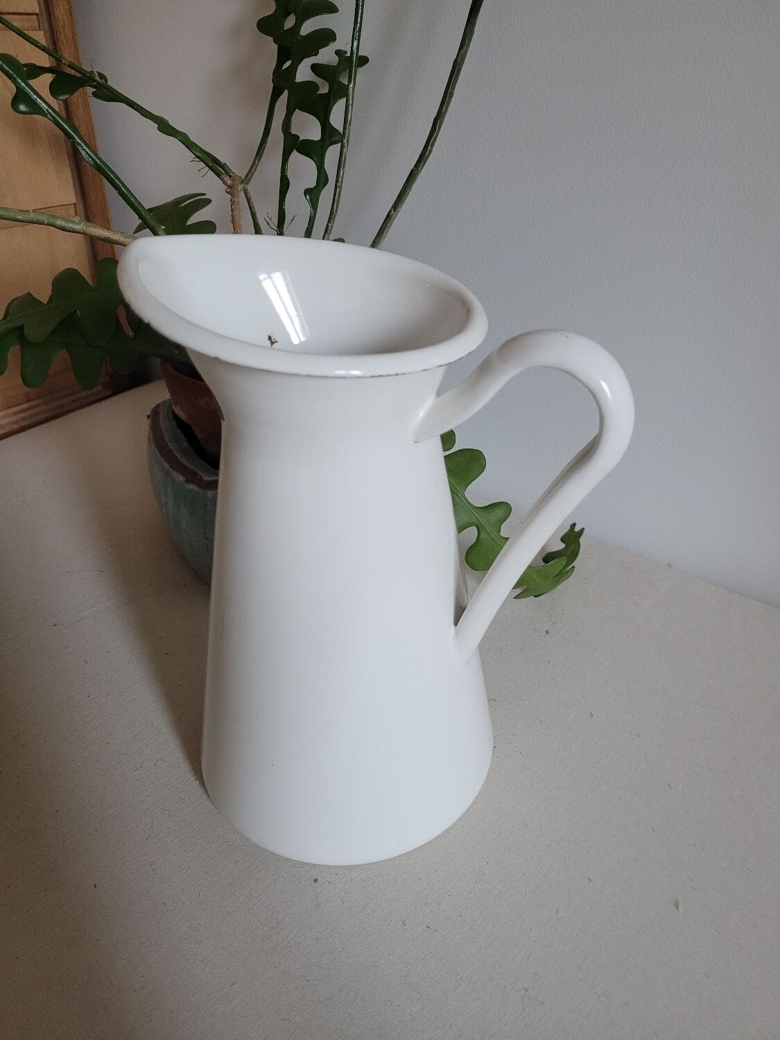 White enamelled metal jug