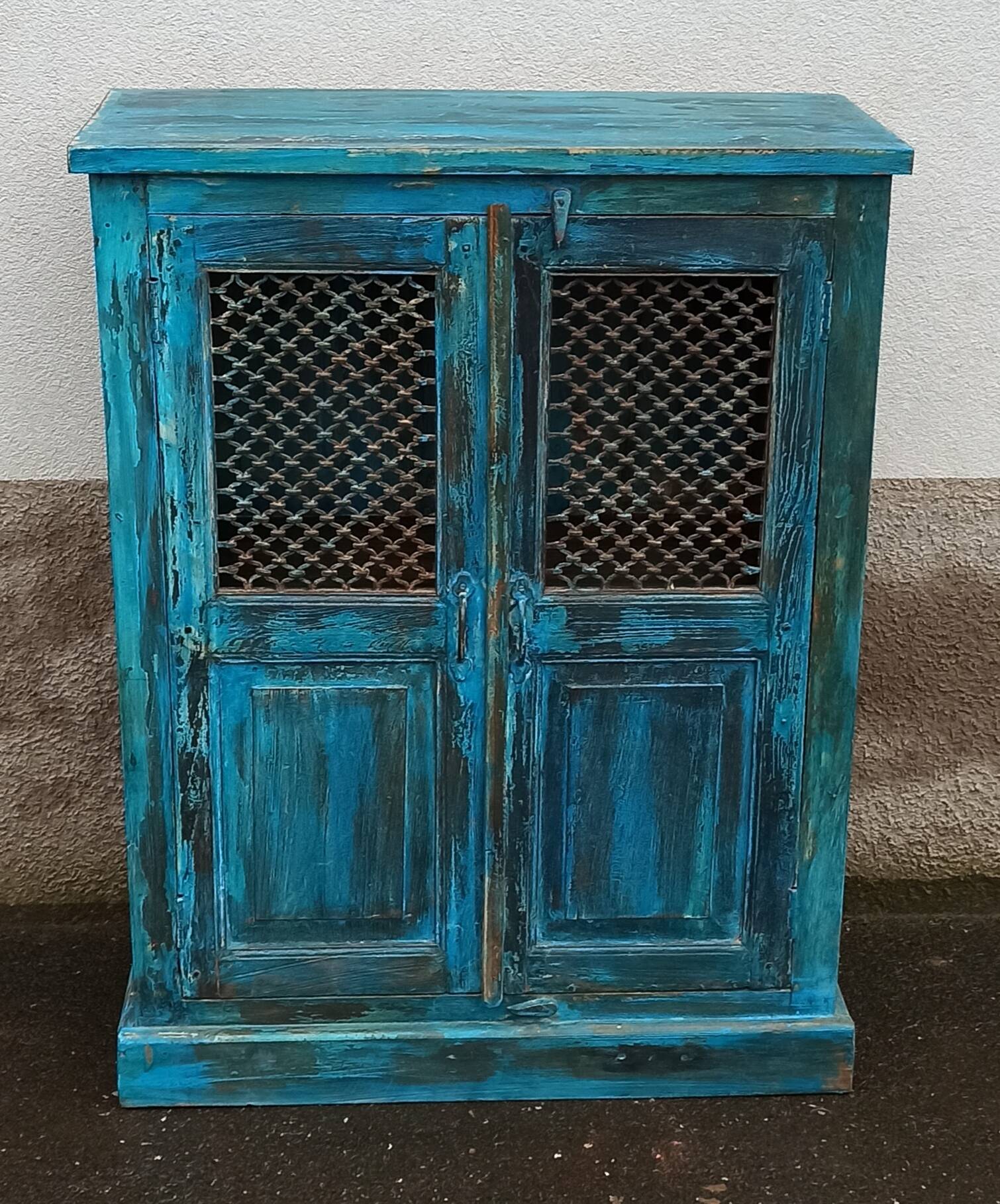 Old wooden cabinet with doors with grille