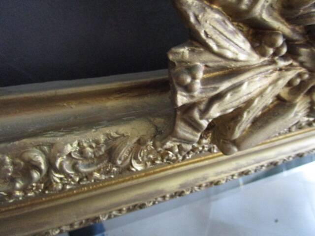 Large antique mirror in wood and gilded stucco.