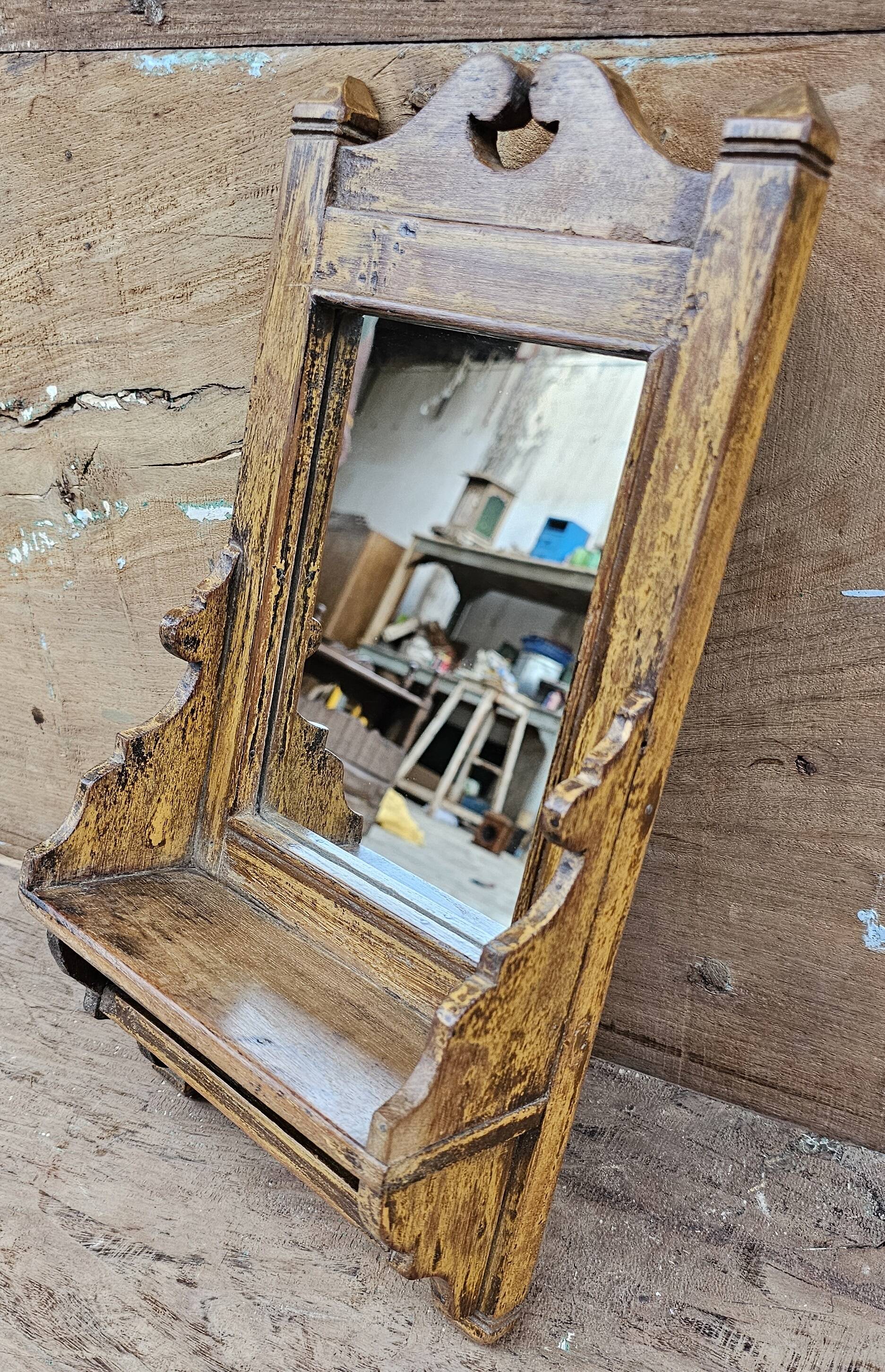 Antique barber's mirror in Burmese teak.