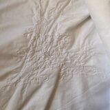 White tablecloth in fine embroidered white cotton.